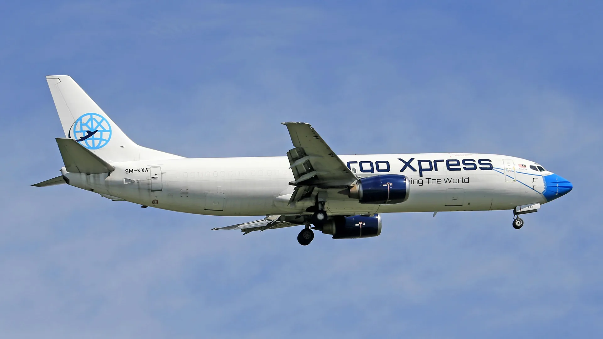 Air cargo aircraft in flight over the clouds